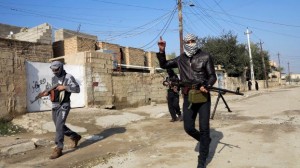 File photo of gunmen fighters walking with their weapons in the streets of the city of Ramadi